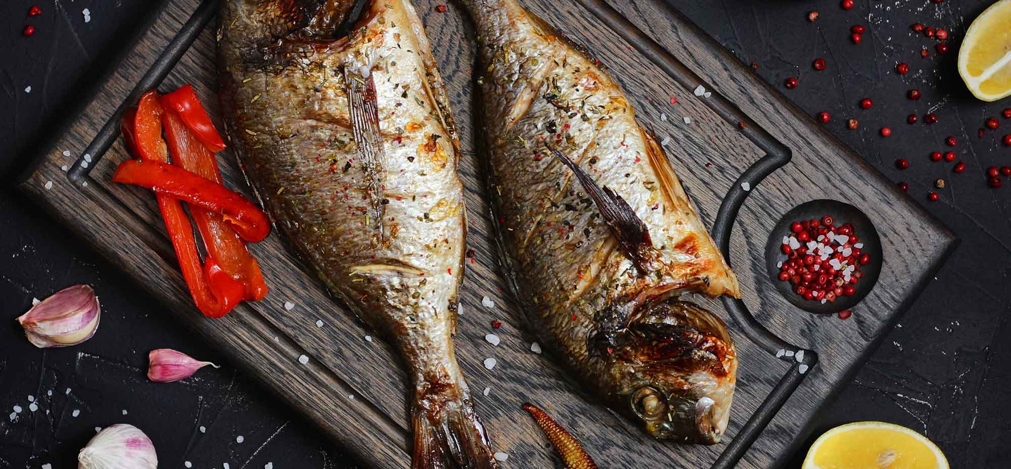 Image of a cooked barramundi flat on a board